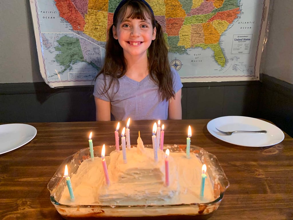 12 year old girl blowing out candles