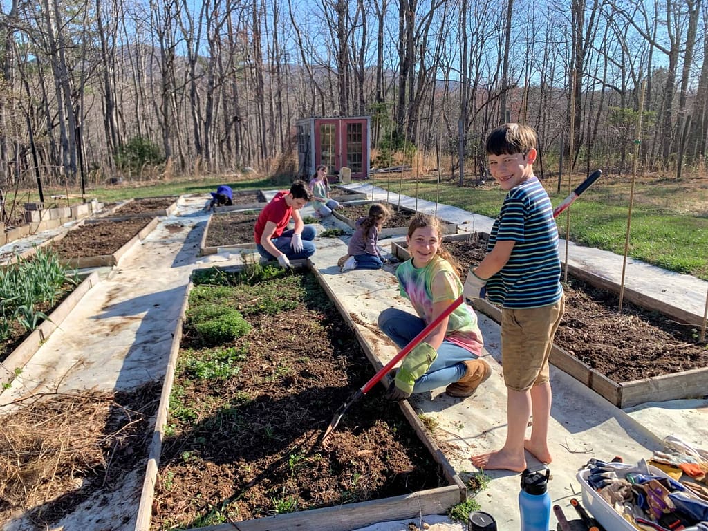 kids working in the garden beds in March