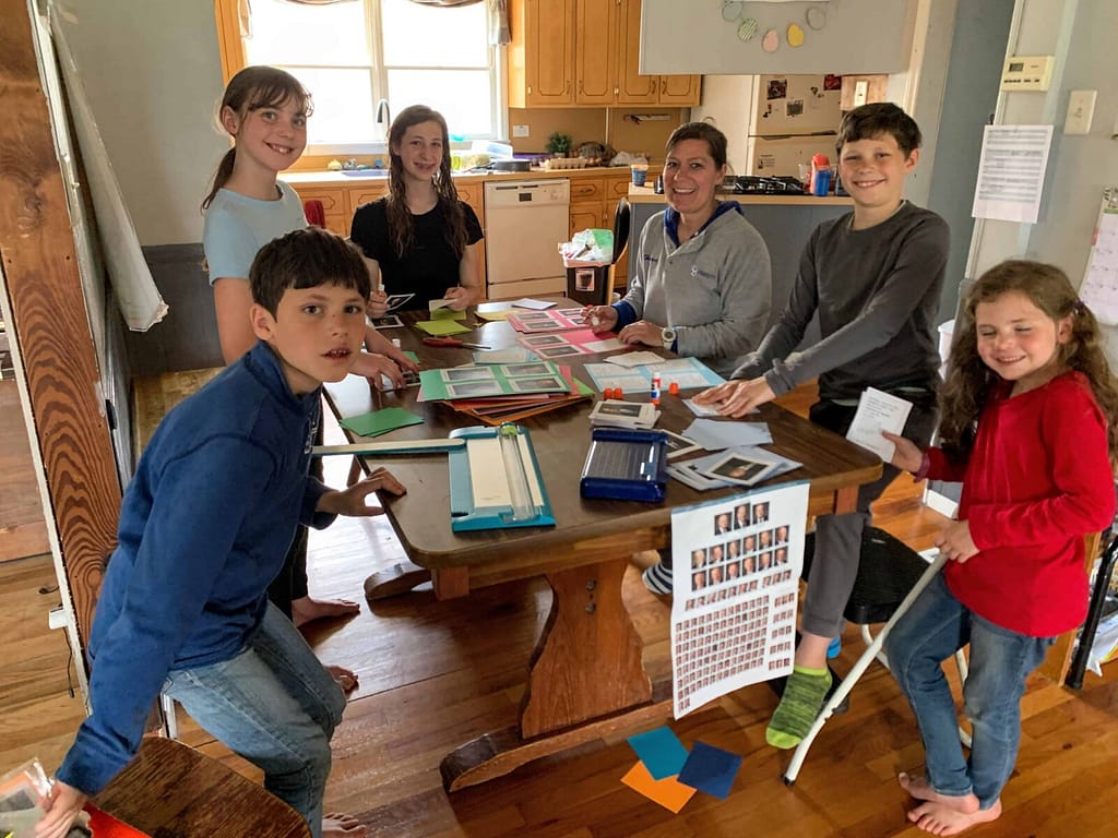 kids assembling apostle cards at the table