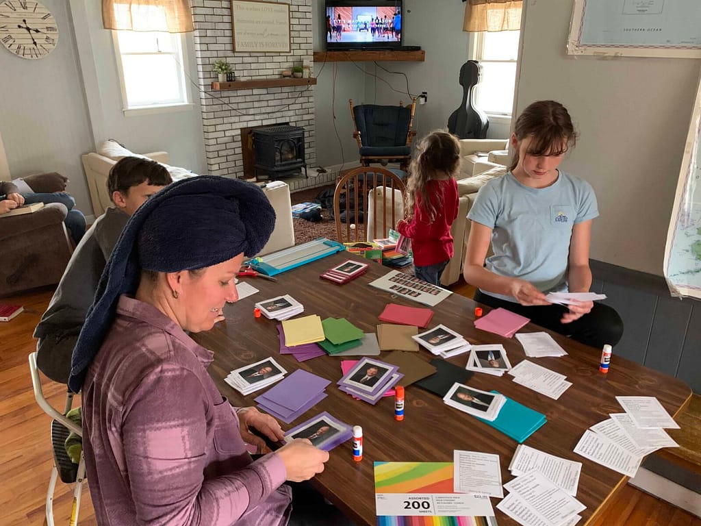 kids assembling apostle cards at the table