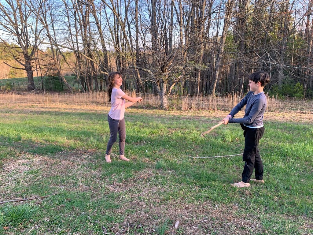 two kids stick sword fighting