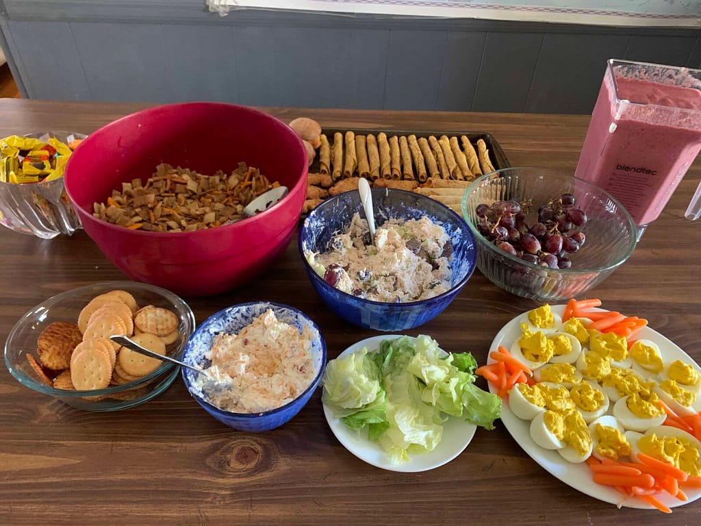 table with chex mix and deviled eggs and snacks