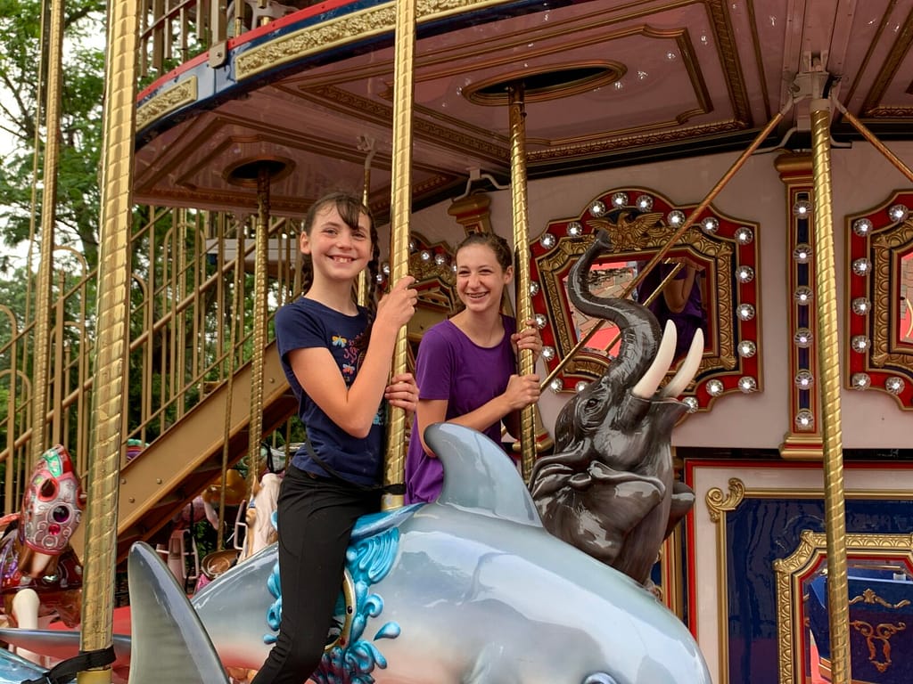 two girls on a carousel