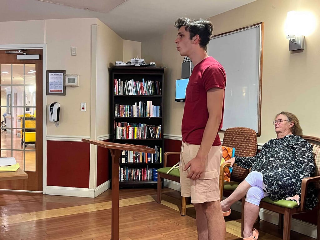 teen boy singing at a nursing home