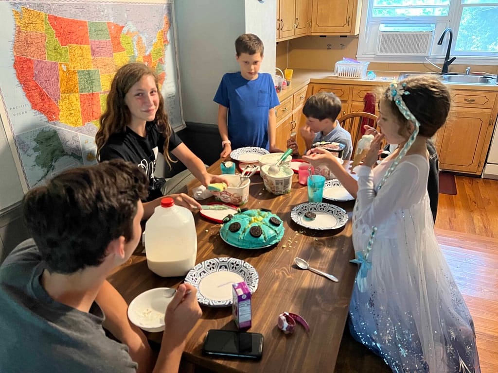family eating cake and ice cream around the table