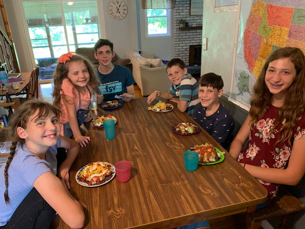 family eating cobb salad around the table