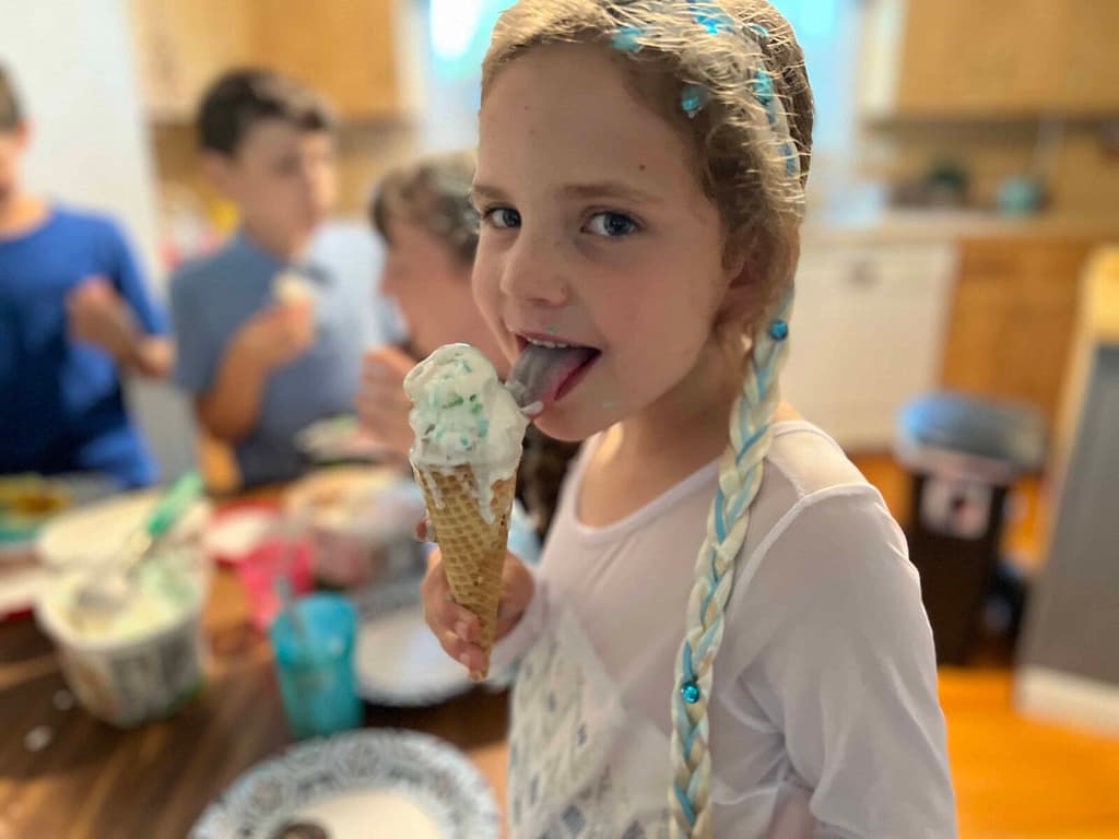 girl licking ice cream cone