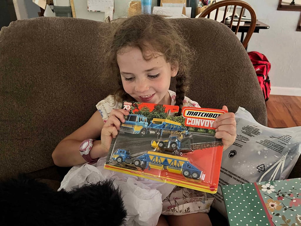 7 year old girl opening a Matchbox semi truck