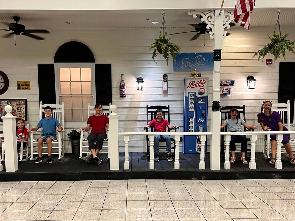 mom and 5 kids on the front porch of GSO