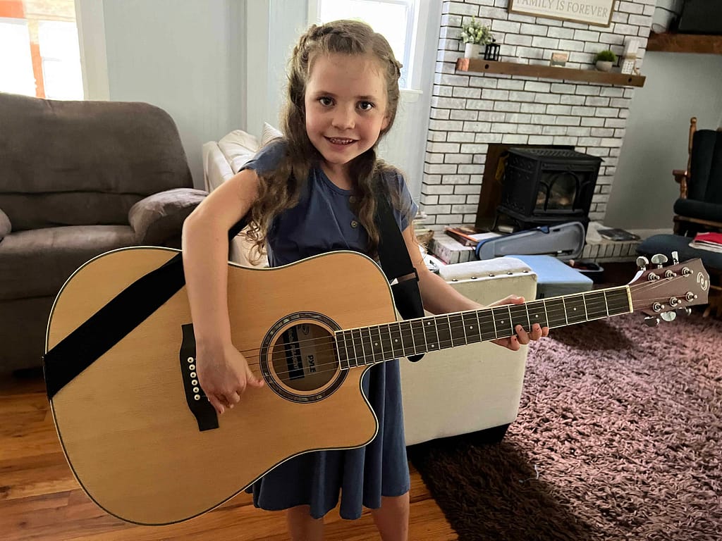 7 year old playing a big guitar