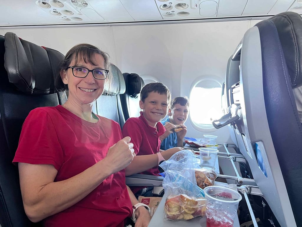 Mom and 2 boys on an airplane