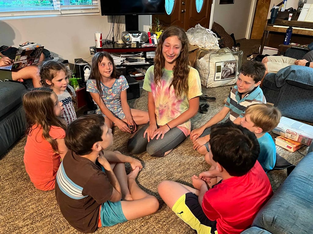 Kids playing a game in a circle in the living room
