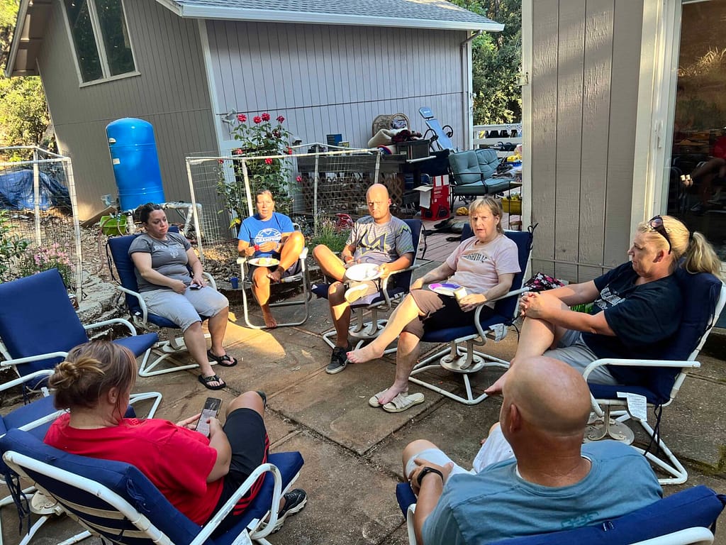 siblings sitting around the patio talking