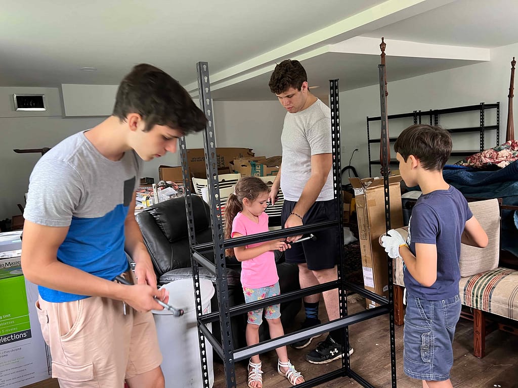 kids putting together a bookshelf