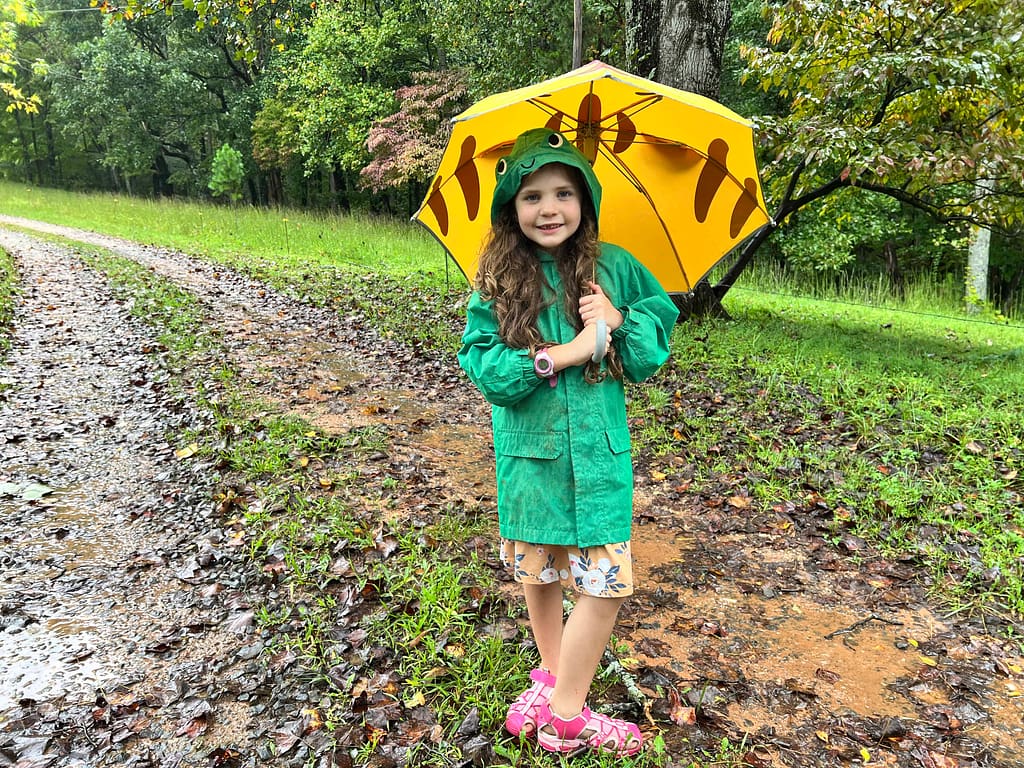 7 year old with umbrella in the rain