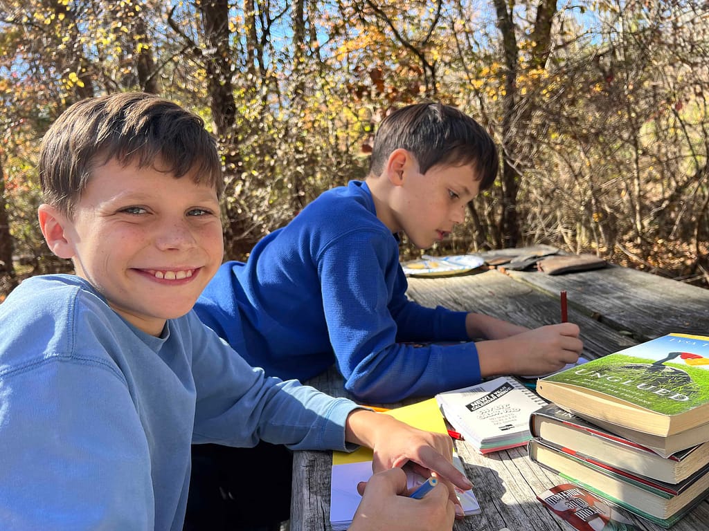 2 brothers drawing at a campground