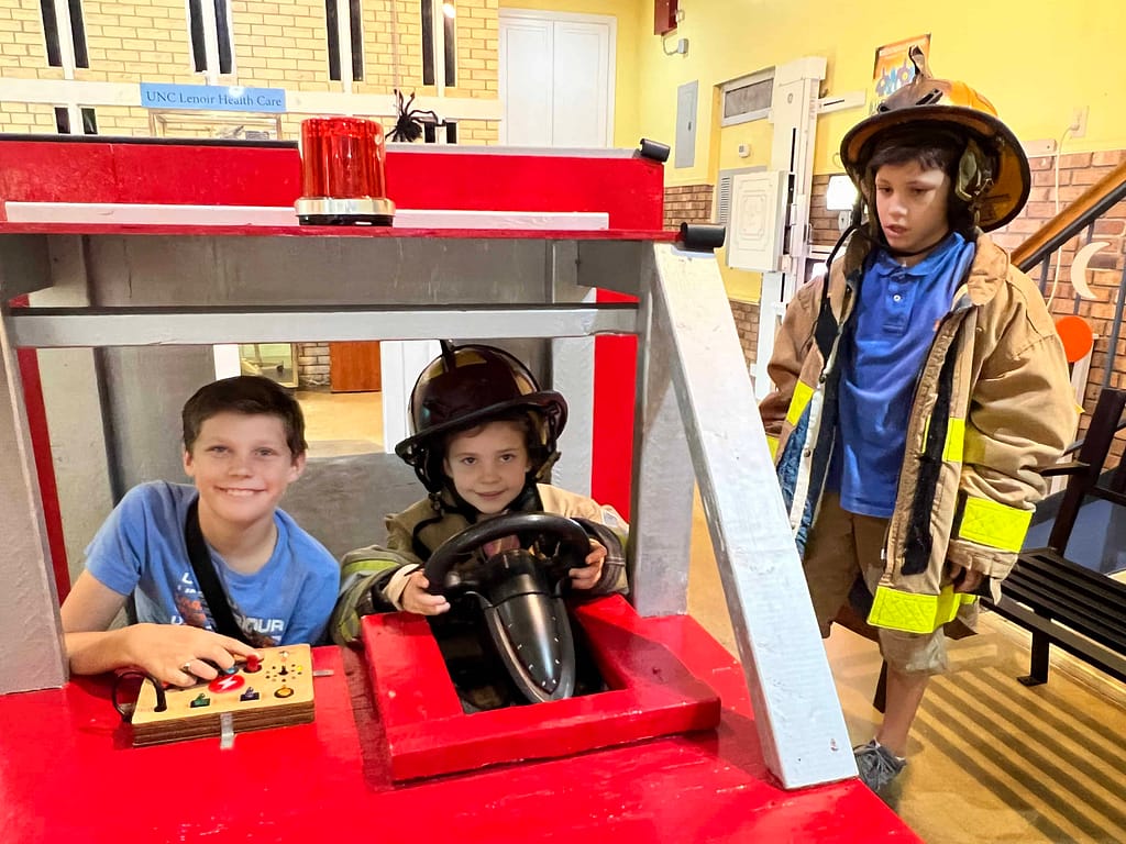 kids play in a fire truck at kinston science center