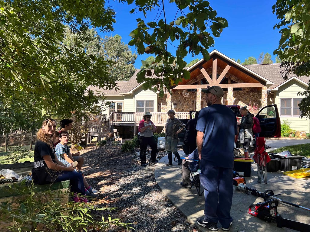 people outside a house eating and walking around