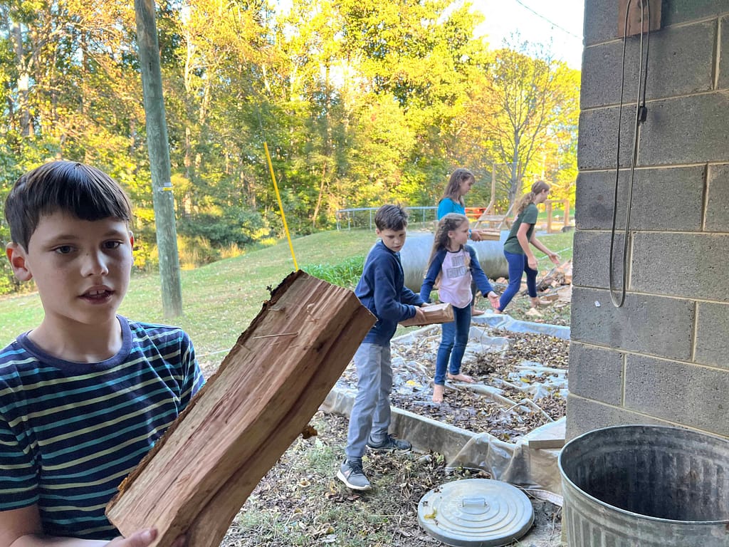kids stacking firewood
