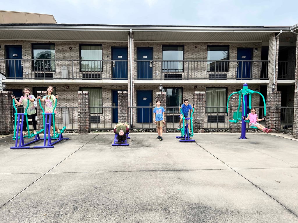 kids playing on exercise equipment at motel