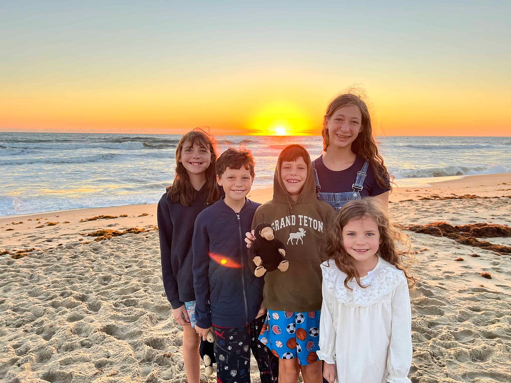 siblings at beach sunrise