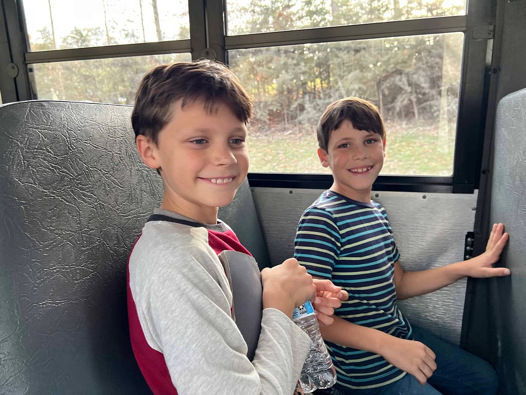 two boys riding a bus