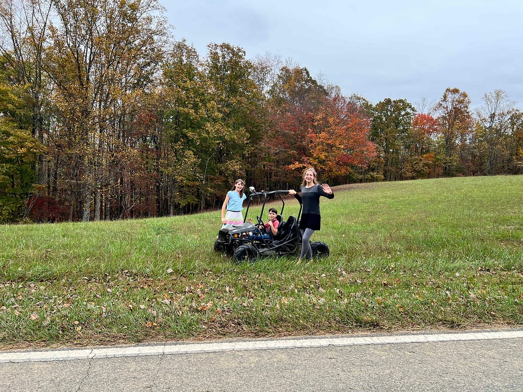 kids waving goodbye in a field