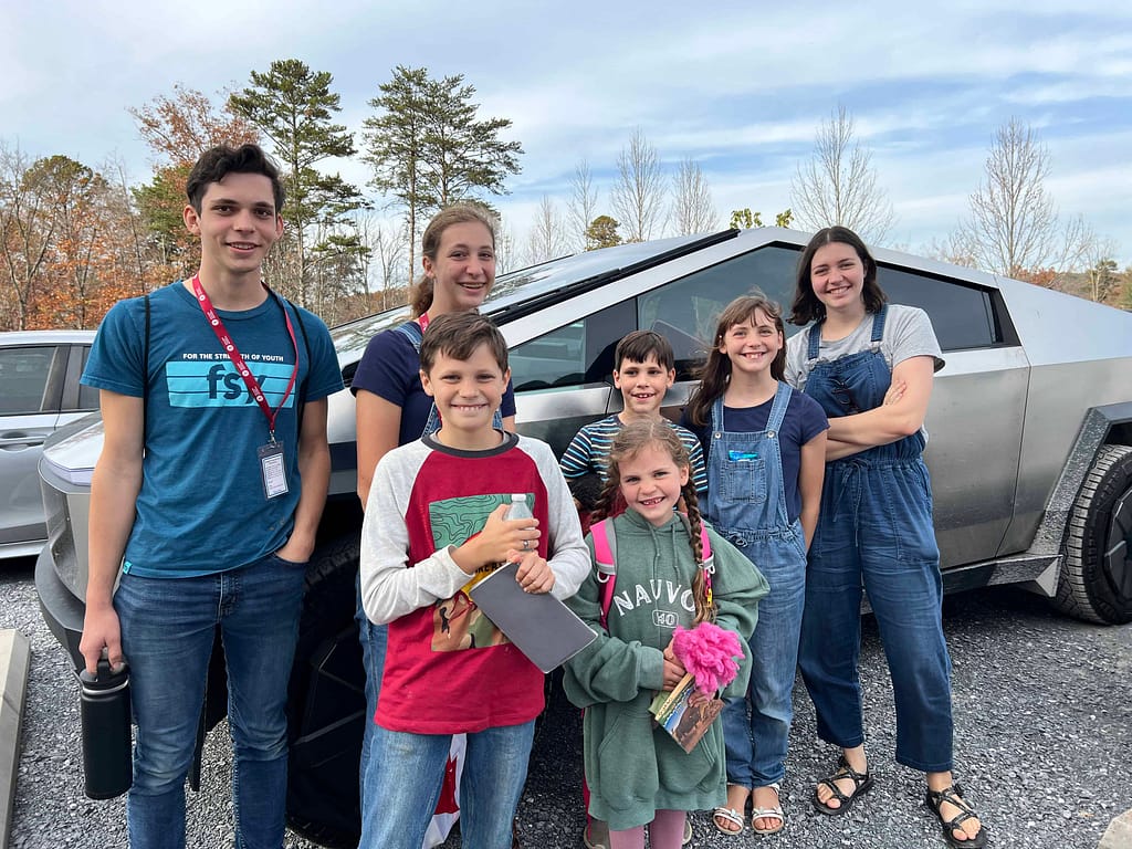 family in front of a cybertruck
