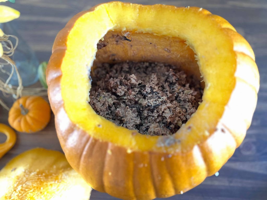 putting the meat mixture inside a pumpkin