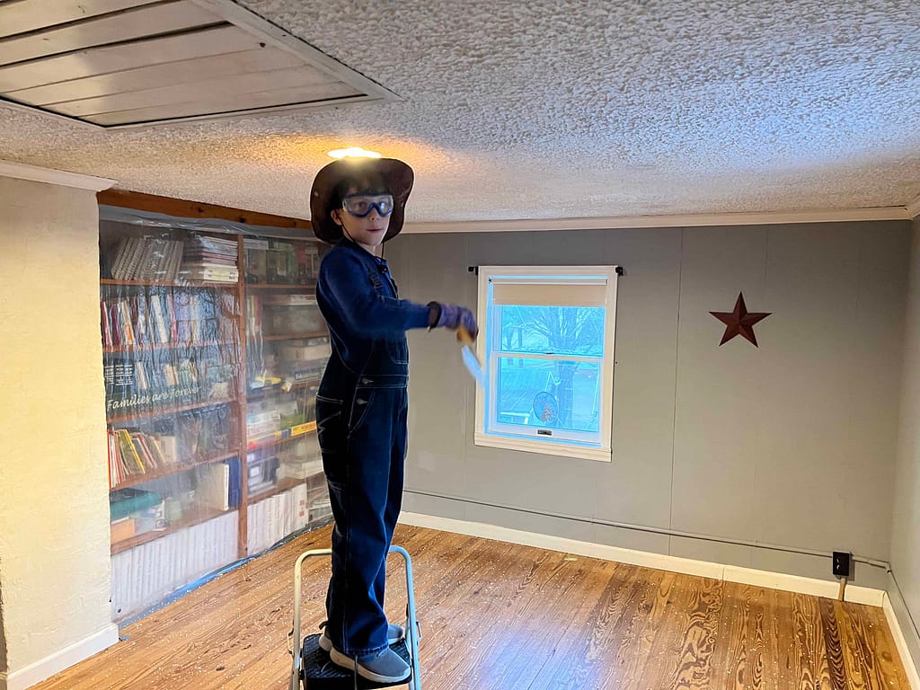 9 year old boy scraping popcorn ceiling