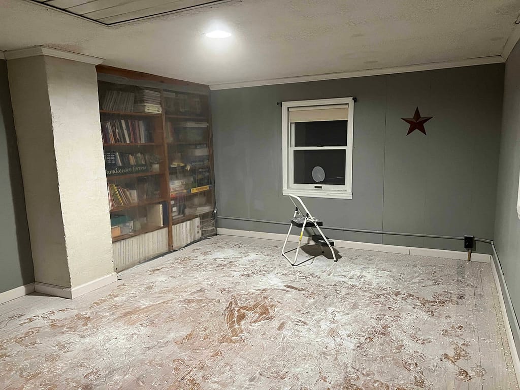 room with dust all over the floor after sanding the ceiling