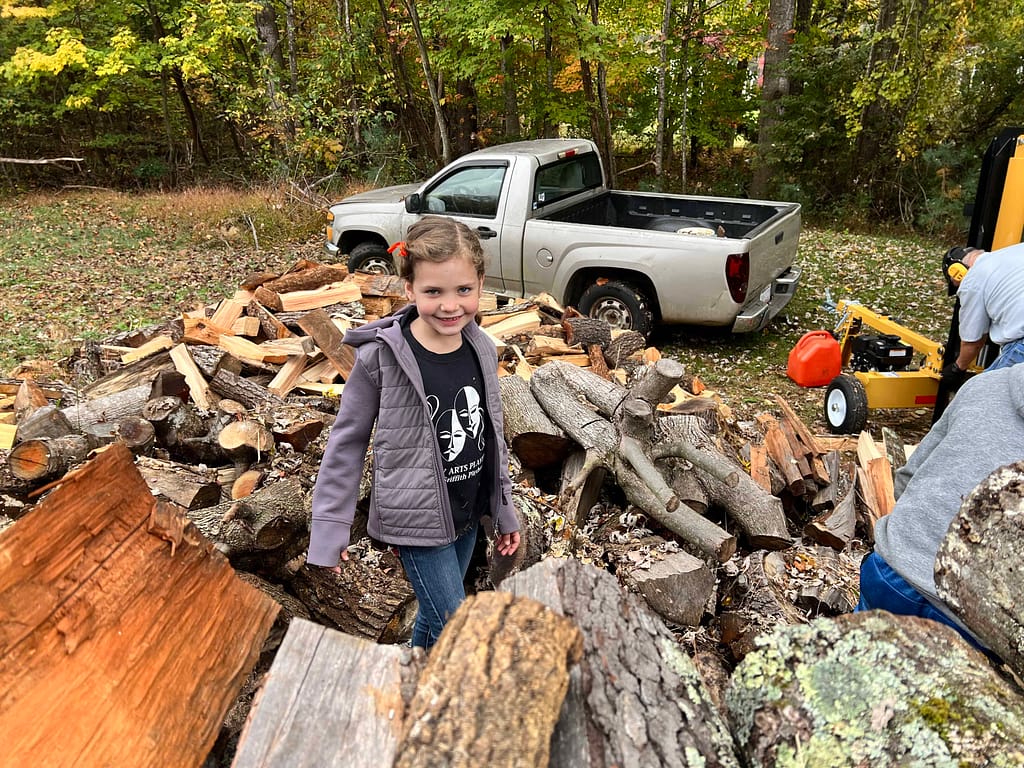 7 year old girl stacking firewood
