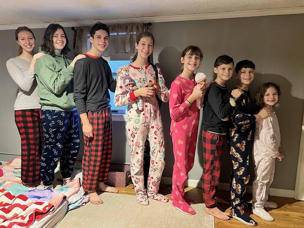 8 kids lined up to go downstairs on Christmas morning