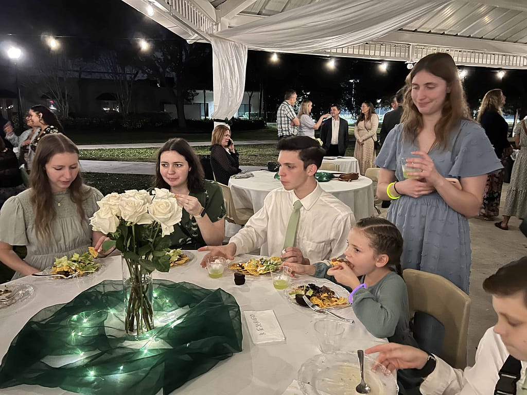 siblings eating at a wedding reception