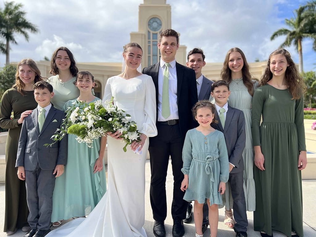 bride and groom with grooms 9 siblings