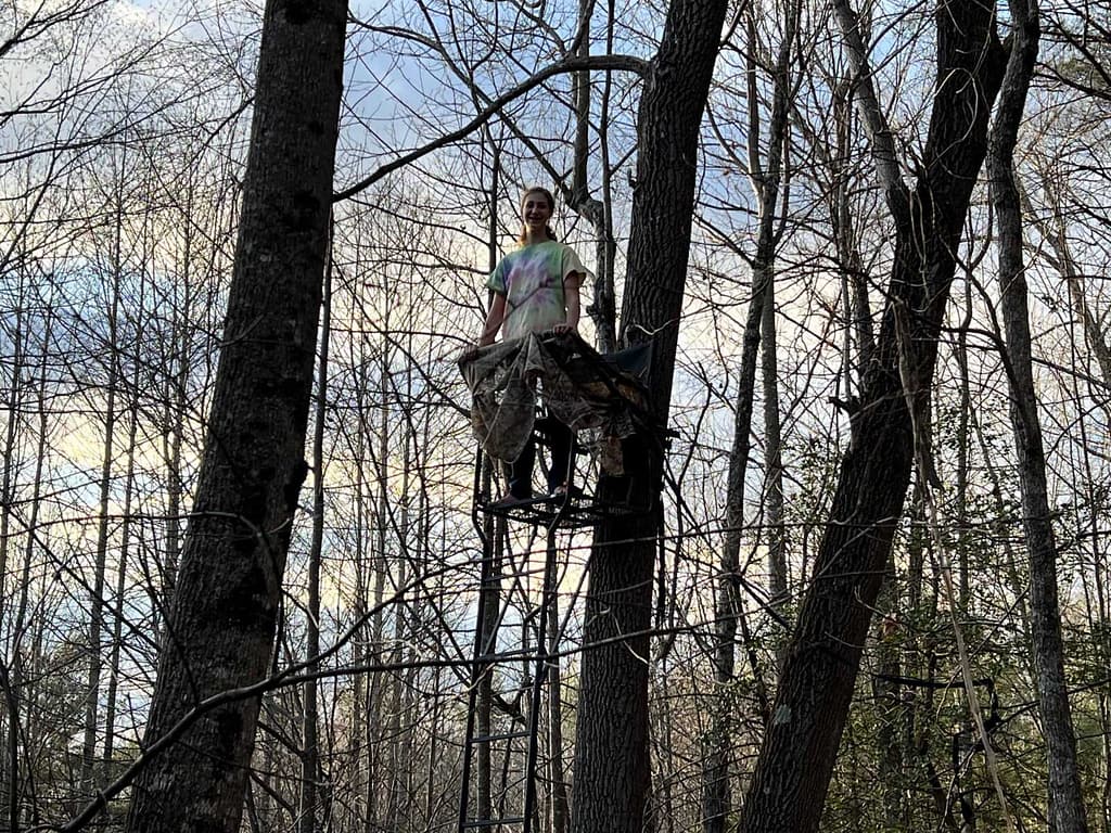 teen girl in a deer stand