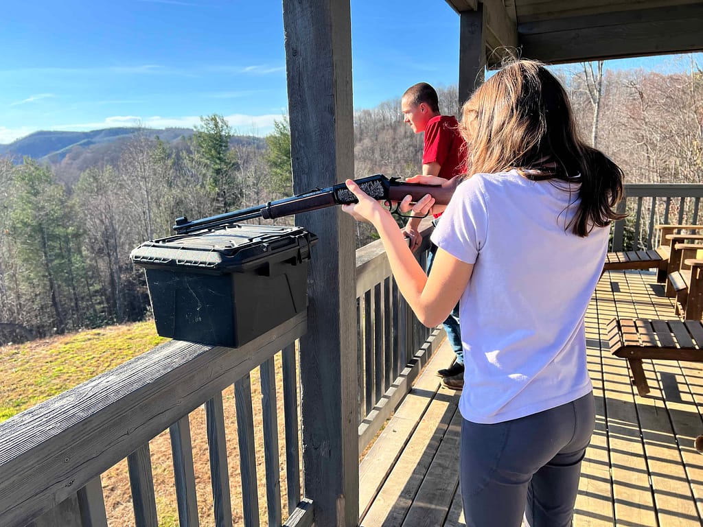 girl learning to shoot a gun