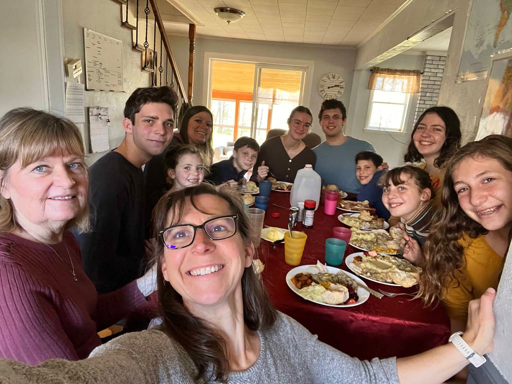large family eating Thanksgiving dinner around the table