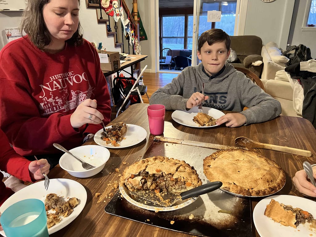 family eating tourtiere at the table