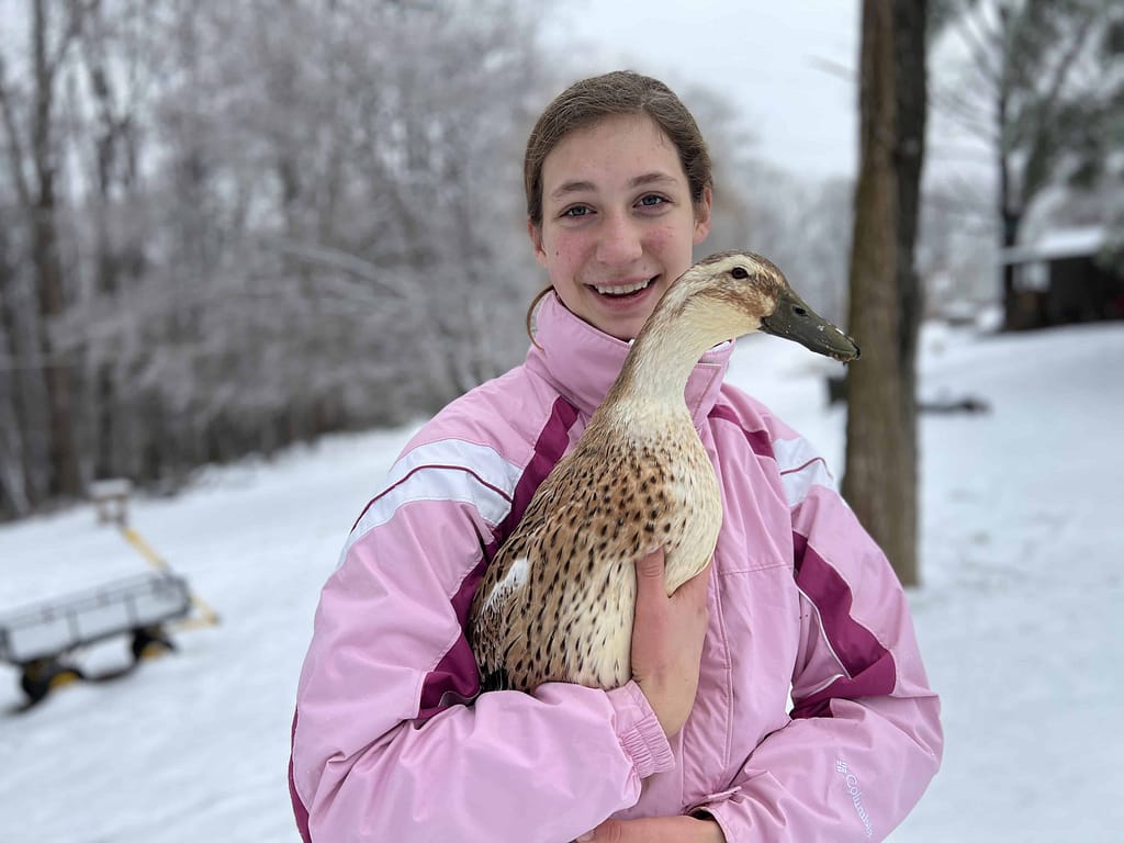 teen girl with duck in snow