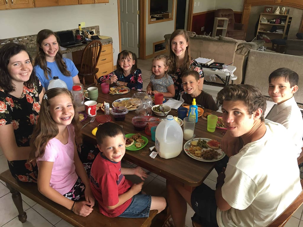 10 kids eating dinner around the table