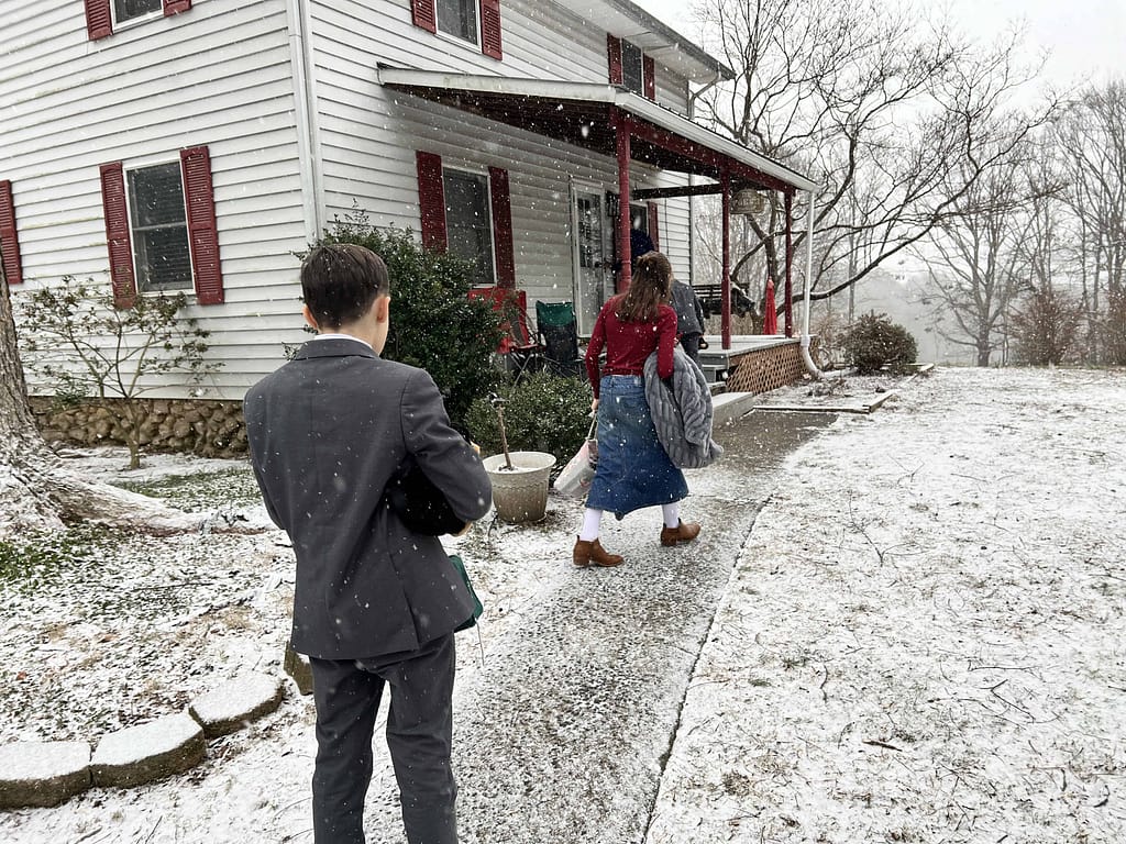kids walking up to house in the snow