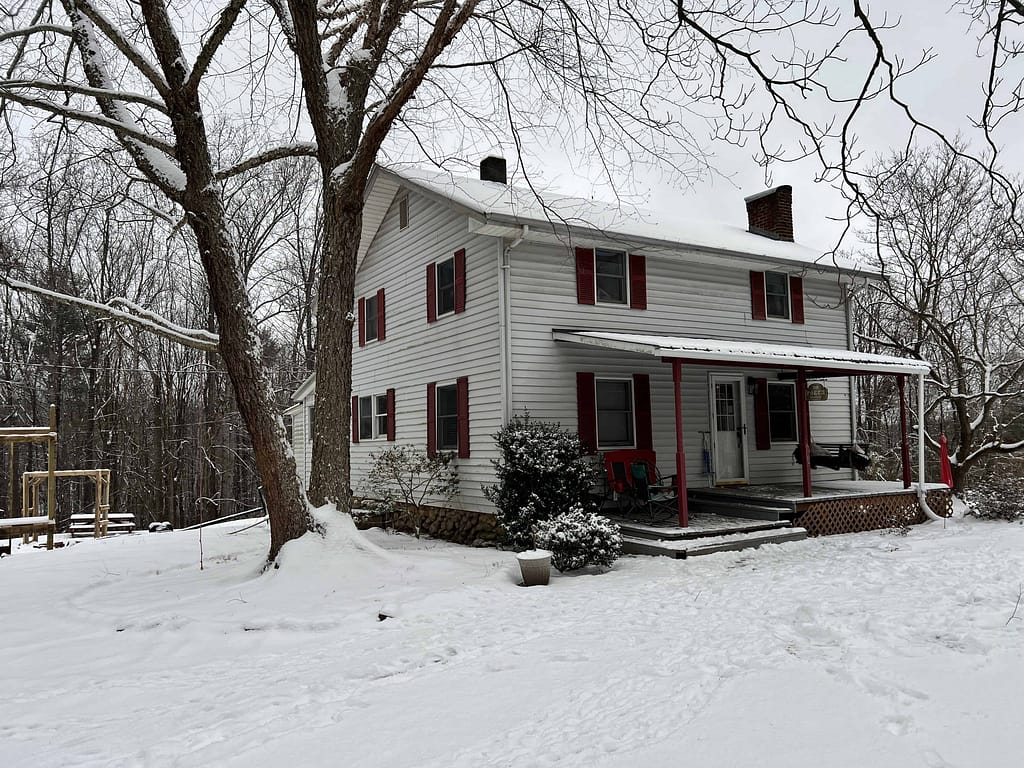 white farmhouse with snow