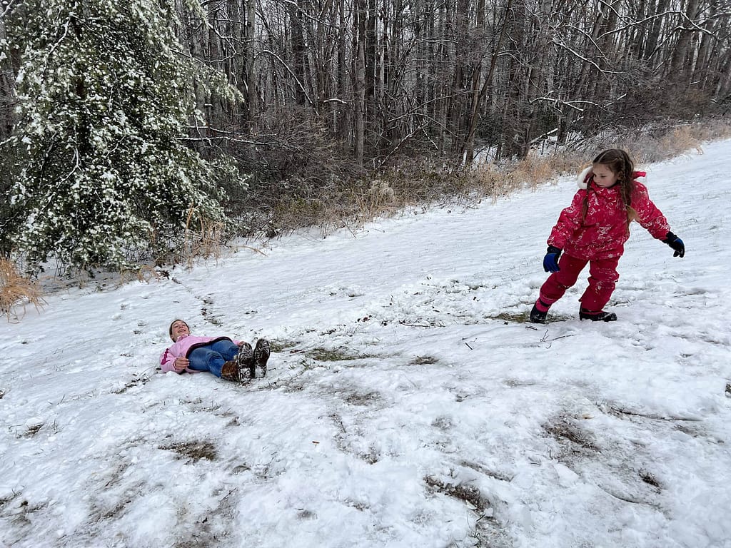 kids sledding on their backs