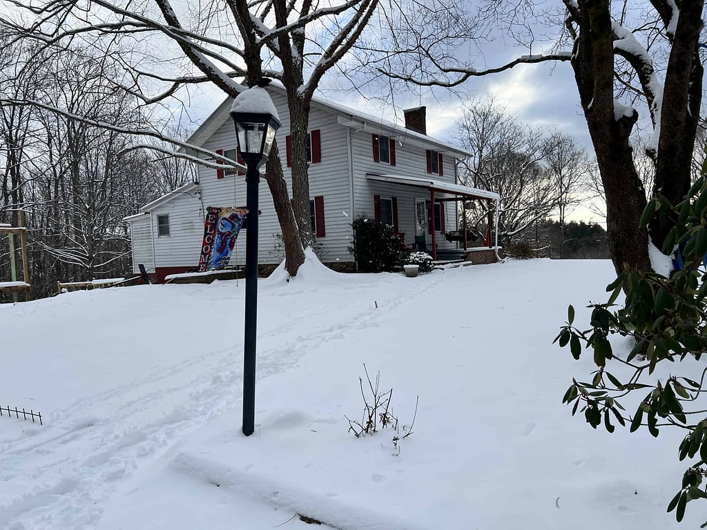 white farmhouse in snow