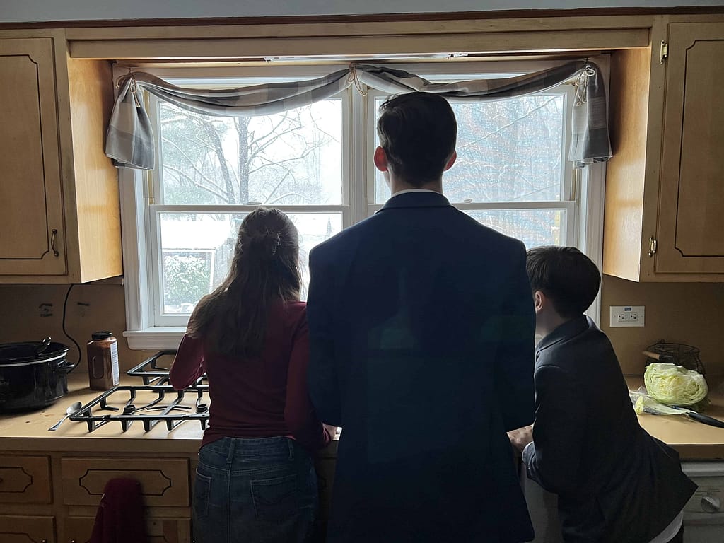 kids watching it snow out the window