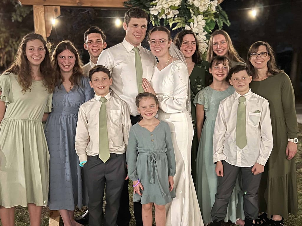 family of mom and 10 kids at son's wedding