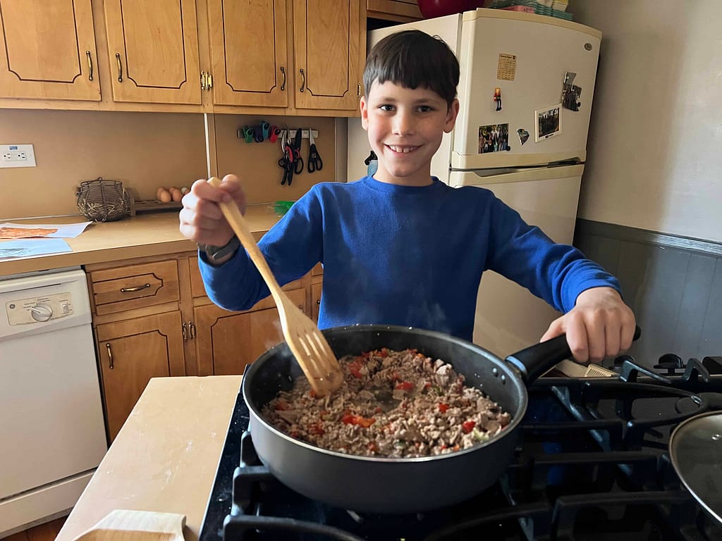 9 year old boy stirs philly cheesesteak