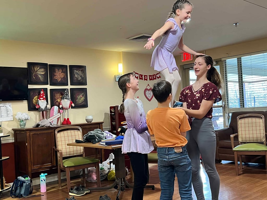 5 siblings doing acro at nursing home