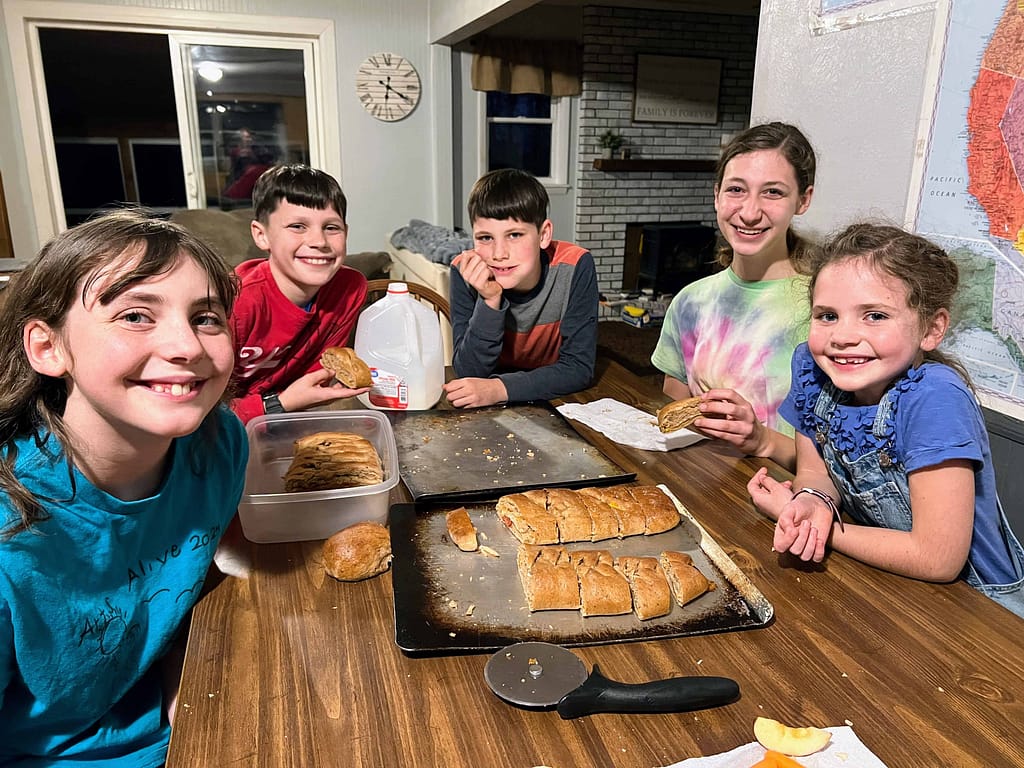 siblings eating stromboli around the table